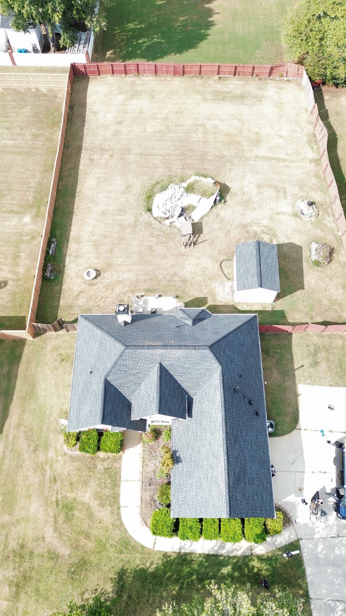 Overhead drone view of a finished GTM roof replacement with a clean work site